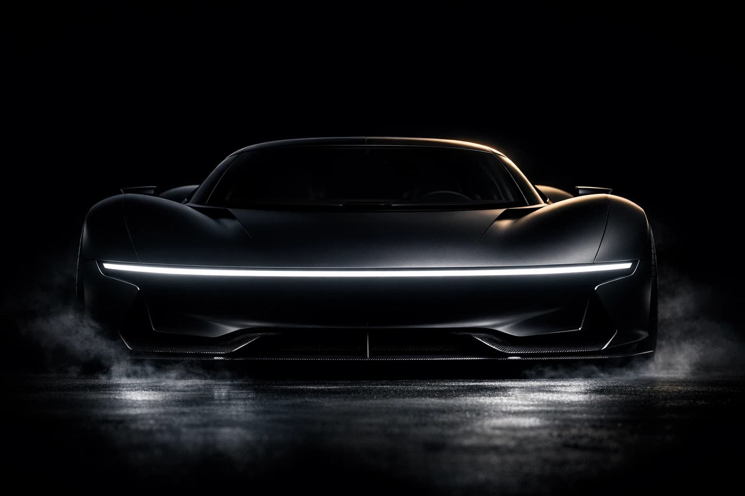 The Nocturne One head on and low: the razor-thin full-width light blade lit, no grille, carbon splitter skimming the floor